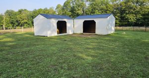 Two Old Hickory Animal Shelters for horses and livestock, durable portable farm shelters with metal roofs for ranches and farms