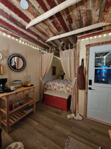 Old Hickory Utility Shed interior, she shed with rustic wood ceiling, cozy bed nook and coffee station, portable backyard studio