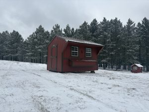 Old Hickory Chicken Coop with nesting box and metal roof in snowy rural setting, ideal for residential or farm use