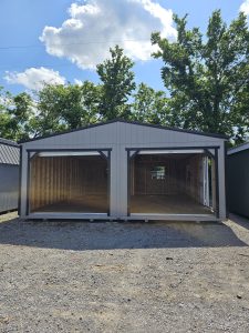 Old Hickory Double Wide Utility Shed with dual roll-up garage door openings, ideal for workshop or storage use