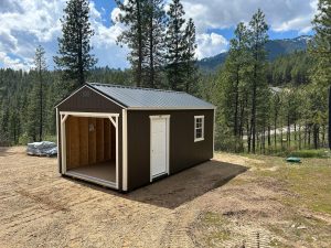 Old Hickory Utility Shed with Garage package and black metal roof, outdoor storage shed in forested mountain setting