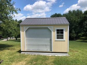 Old Hickory Utility Shed with Garage package, roll-up door and window, portable outdoor storage shed on manicured lawn