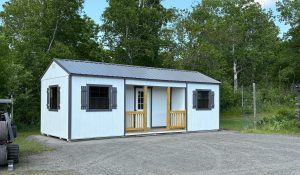Old Hickory Utility Center Porch shed with metal roof in wooded backyard setting, ideal for office, workshop or storage use