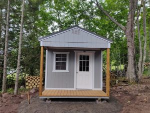 Old Hickory Utility Shed with Playhouse package in Gap Gray, porch and 9-lite door, backyard storage shed in wooded setting
