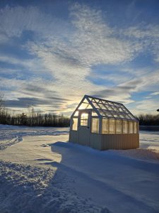 An Old Hickory Greenhouse in Navajo White surrounded by white snow in a Winter escape.