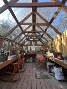 Old Hickory Greenhouse interior with clear roof panels, spacious backyard greenhouse transformed to cozy garden studio